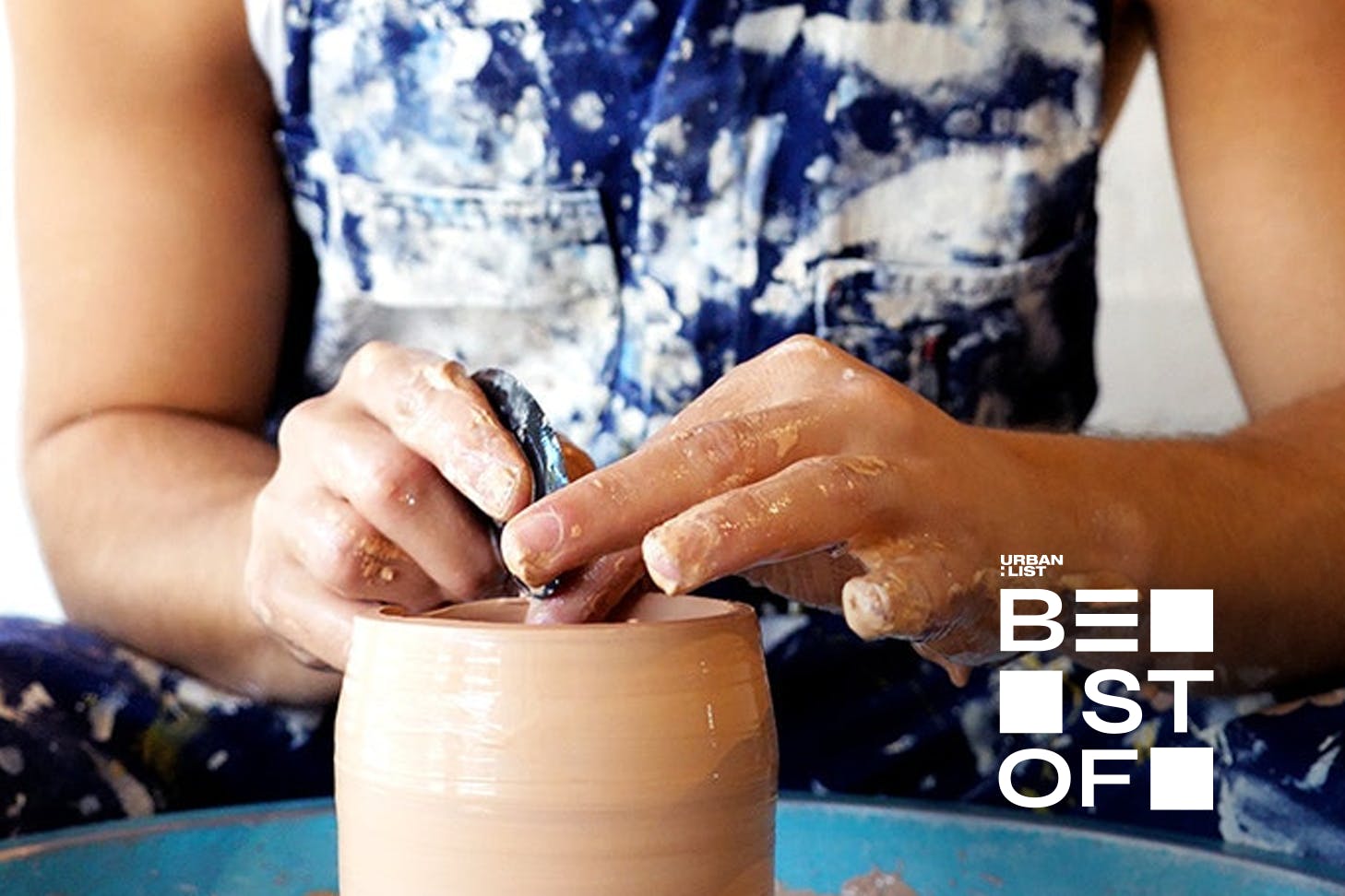 A person working on a ceramic piece.